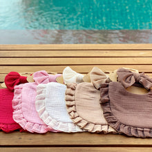 Load image into Gallery viewer, This set includes a cute drool bib and a matching headband bow. The absorbent multi-layer bib is made of 100% soft muslin cotton and it is easy to snap on a baby. The bow is made of stretchy ribbed cotton and can be used with the matching bib or styled with any outfit. The set is suitable for newborns and toddlers alike. Dubai, Abu Dhabi, UAE
